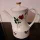 White porcelain coffee service of 3 pieces with a rose design.