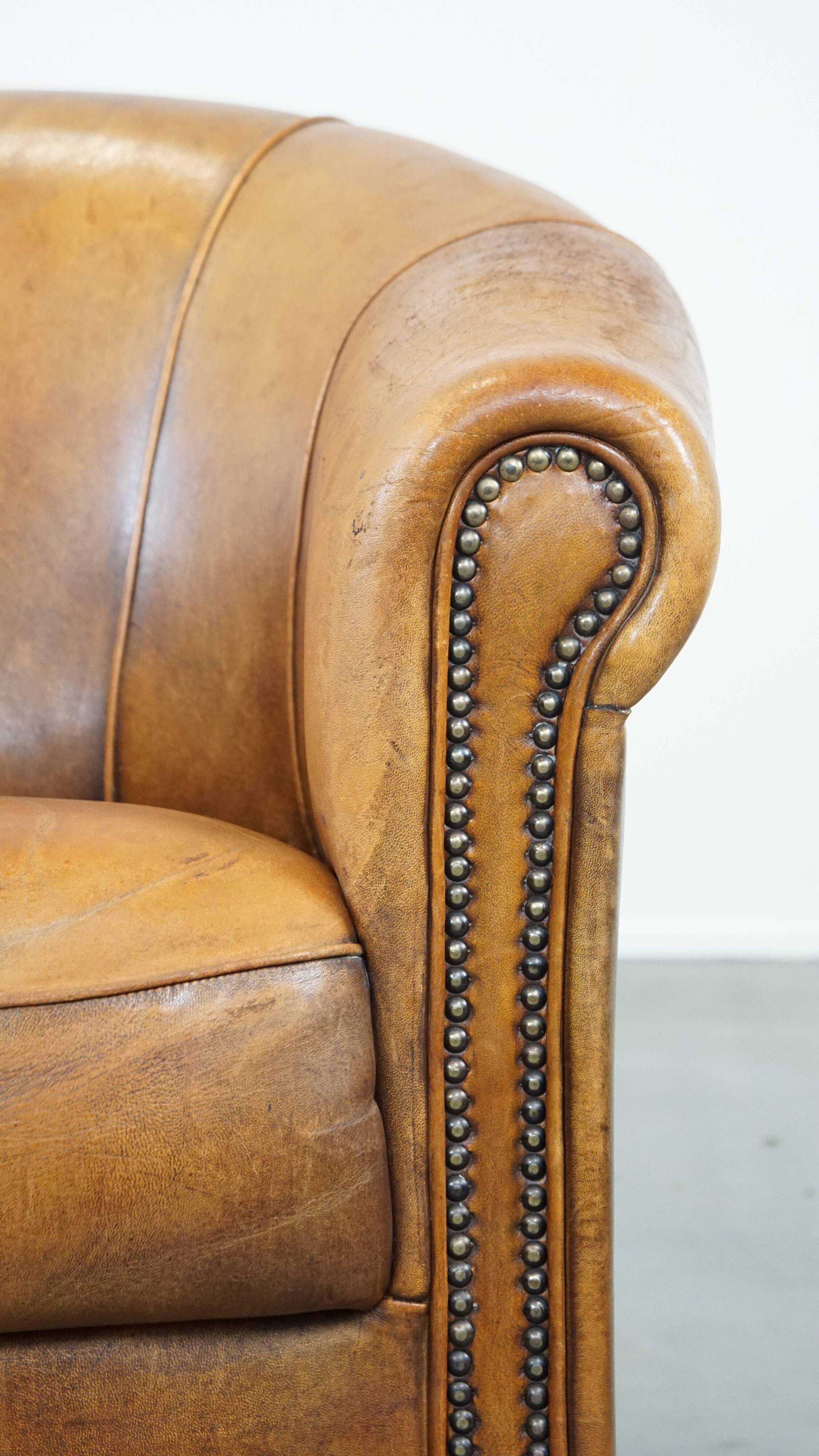 Cognac-colored sheep leather club chair with patina
