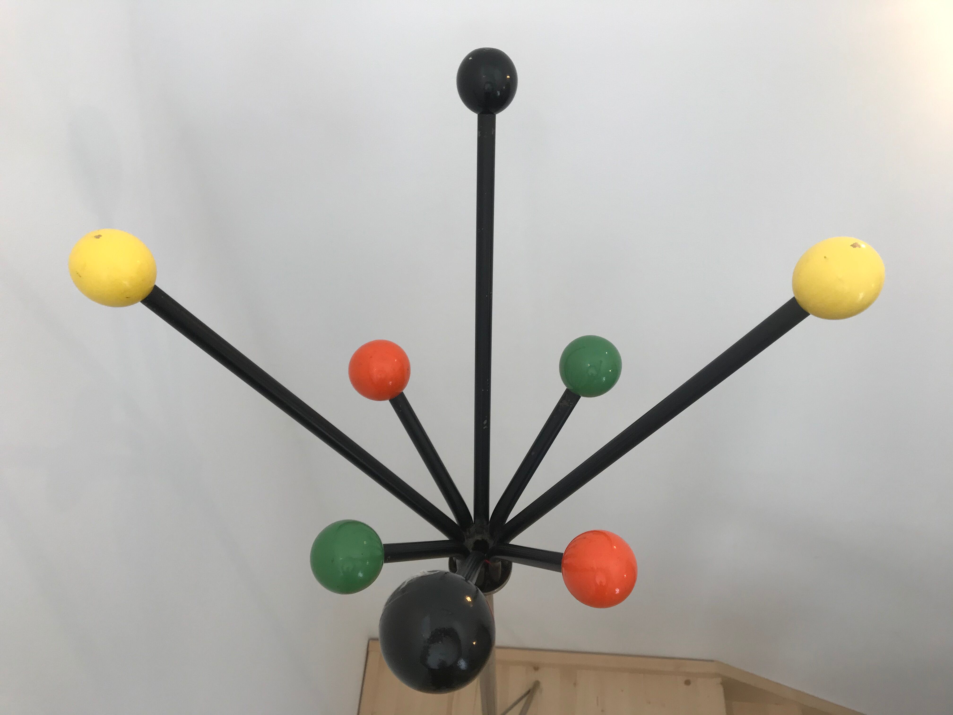 Wearing chrome parrot coat, black and multicolored balls