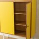 Classic sideboard from the 1960s, oak veneer, yellow Resopal, white steel feet