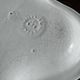 Antique oval-shaped white crackled faience plate with a scalloped edge.