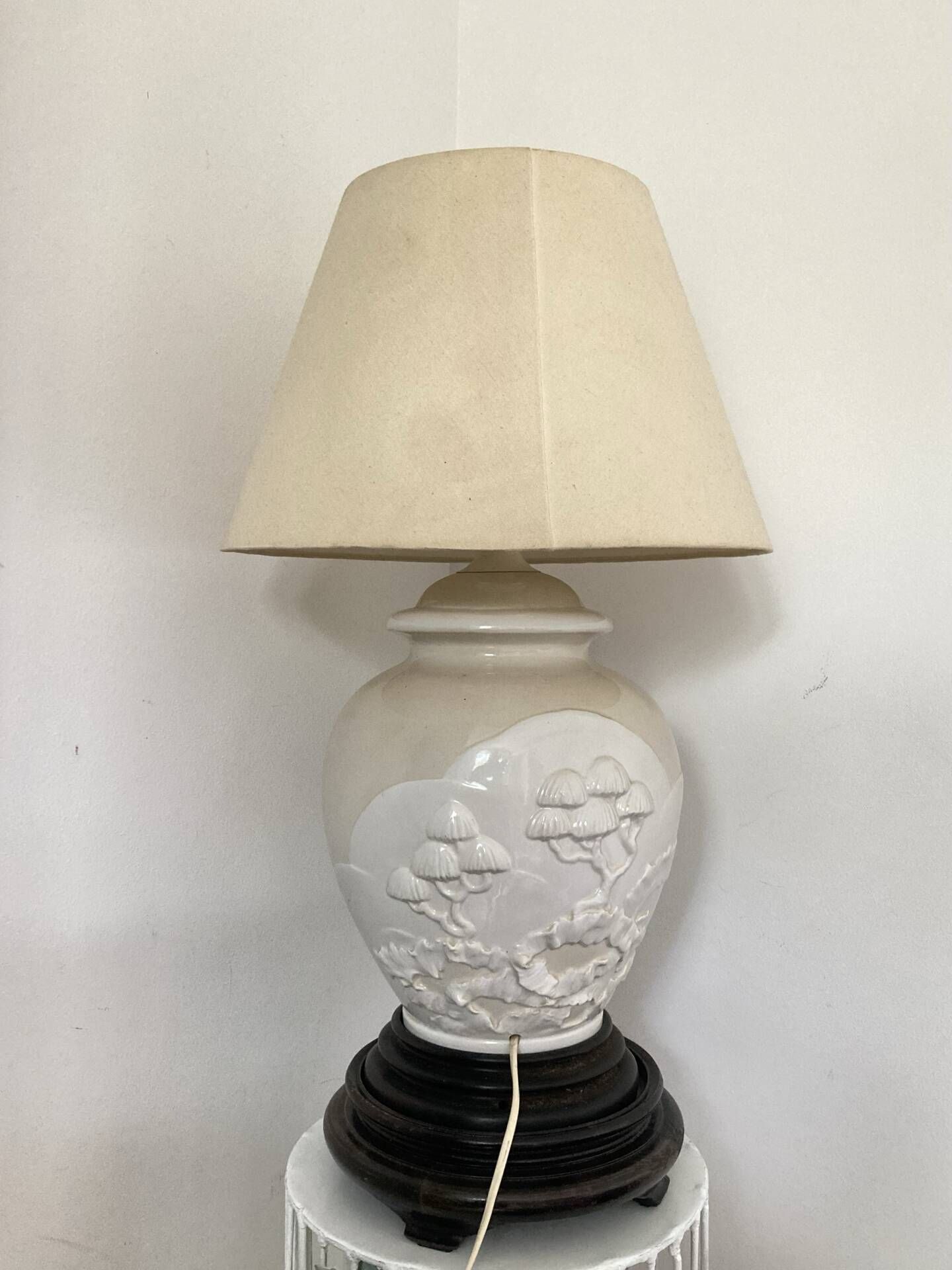 1980s ceramic table lamp with a wooden base and adjustable shade.