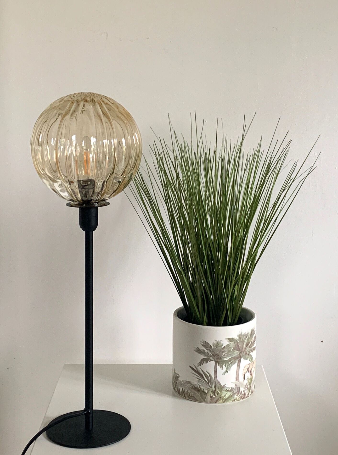 Table lamp with an antique golden streaked globe and a golden foot
