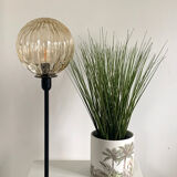 Table lamp with an antique golden streaked globe and a golden foot