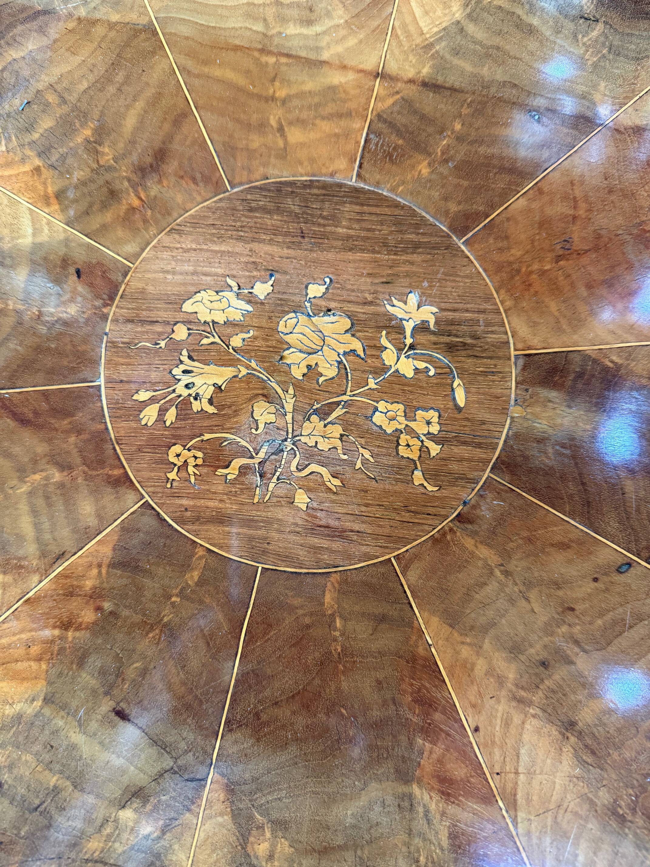 Antique round table with floral details.