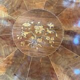 Antique round table with floral details.