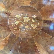 Antique round table with floral details.