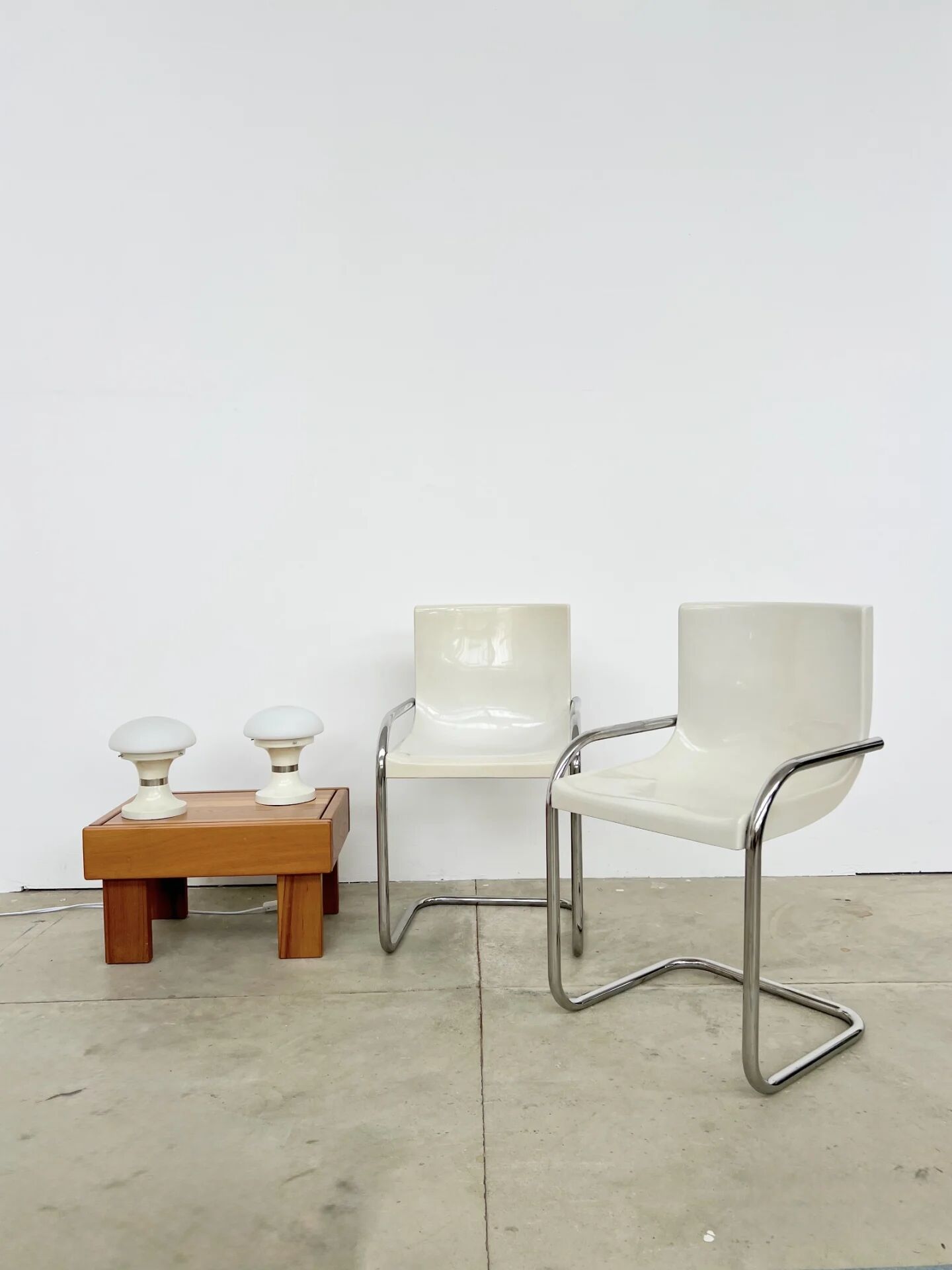 Pair of white moulded shell chairs with chrome tube — Space Age 70s