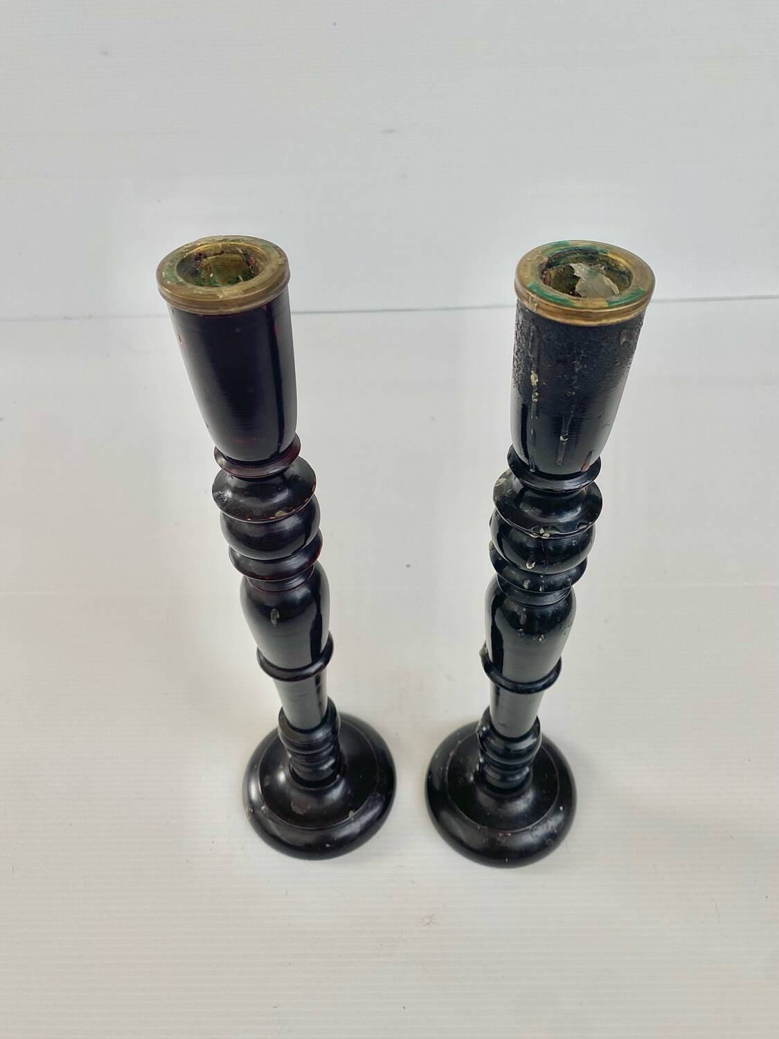 Pair of antique ebonised wooden candlesticks from the 19th century.