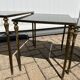 Nested tables in gilded brass in the style of Maison Charles.