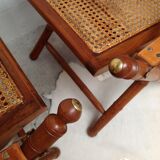 Pair of folding chairs in bamboo and caning, leather and brass