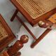 Pair of folding chairs in bamboo and caning, leather and brass