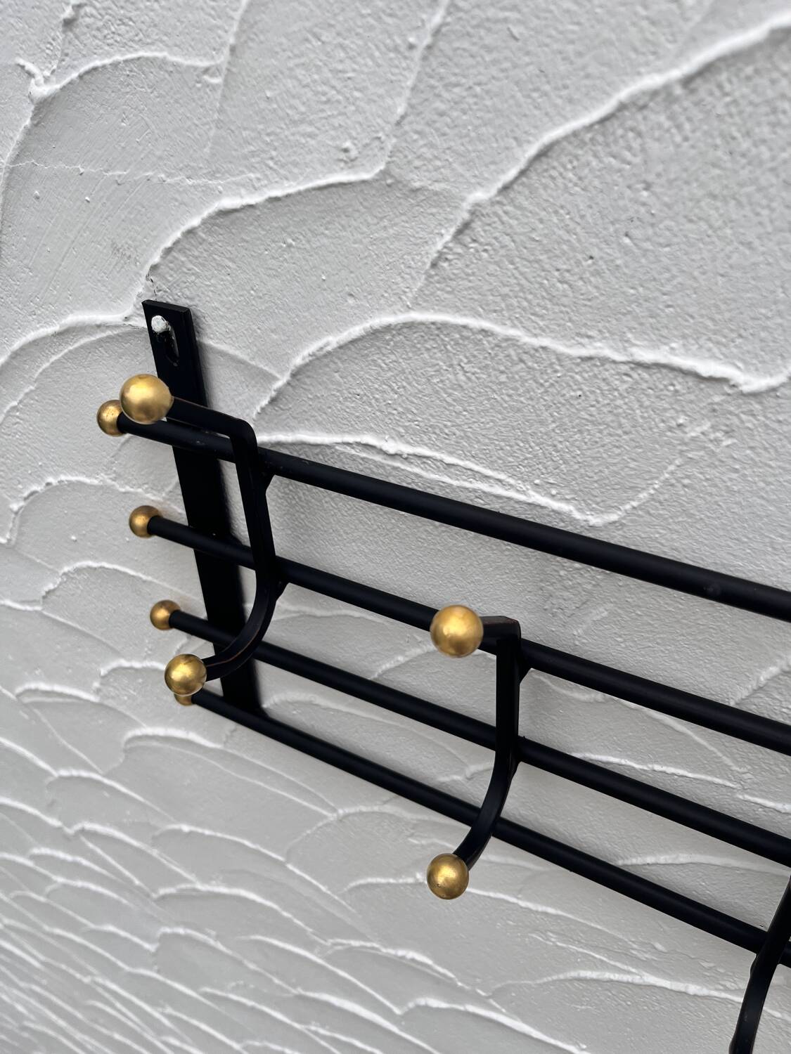 Iron and brass coat rack