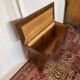 Small antique oak chest with carved panels.