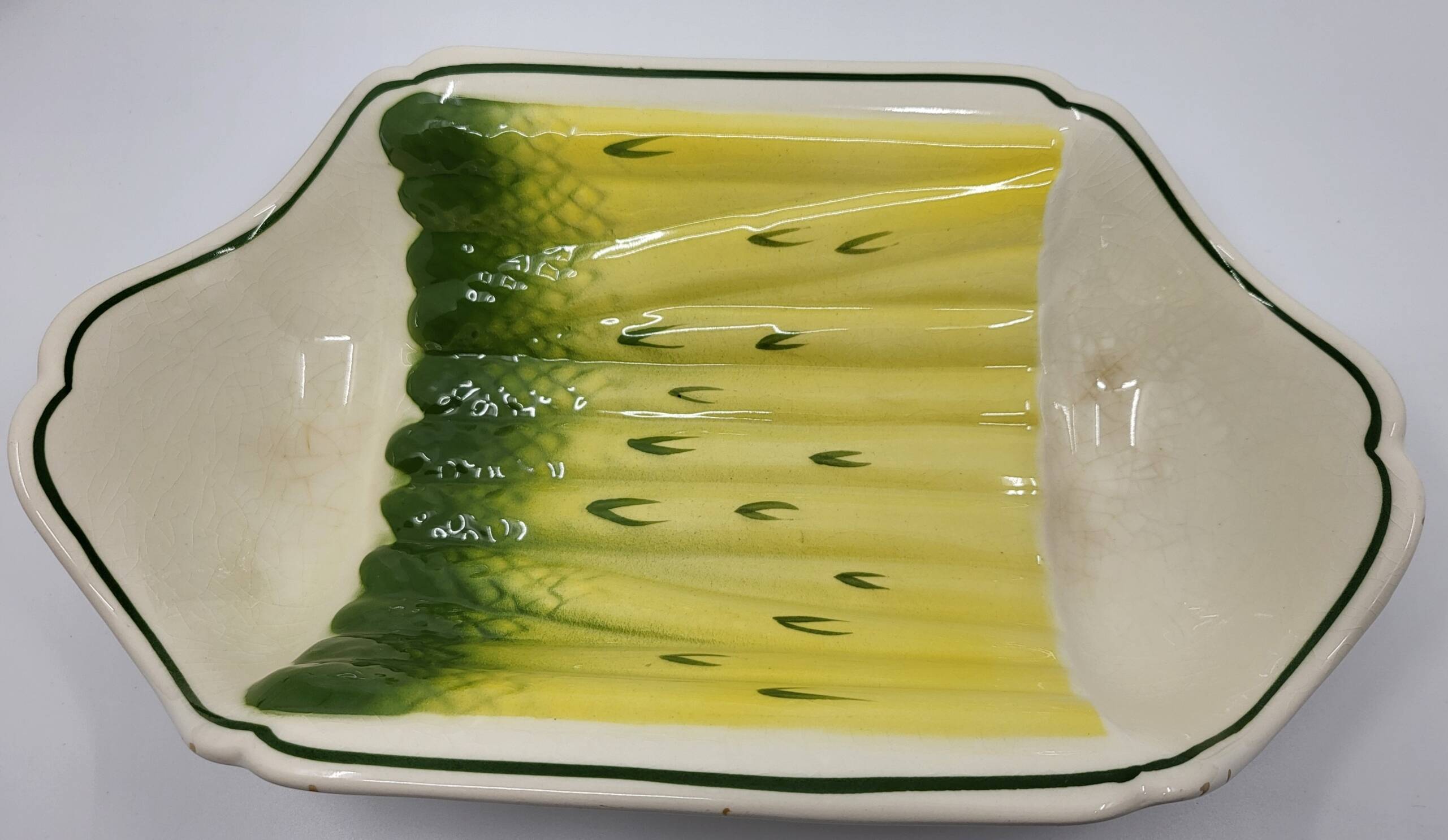 Salins earthenware slip dish decorated with asparagus, French, yellow and green, 20th century