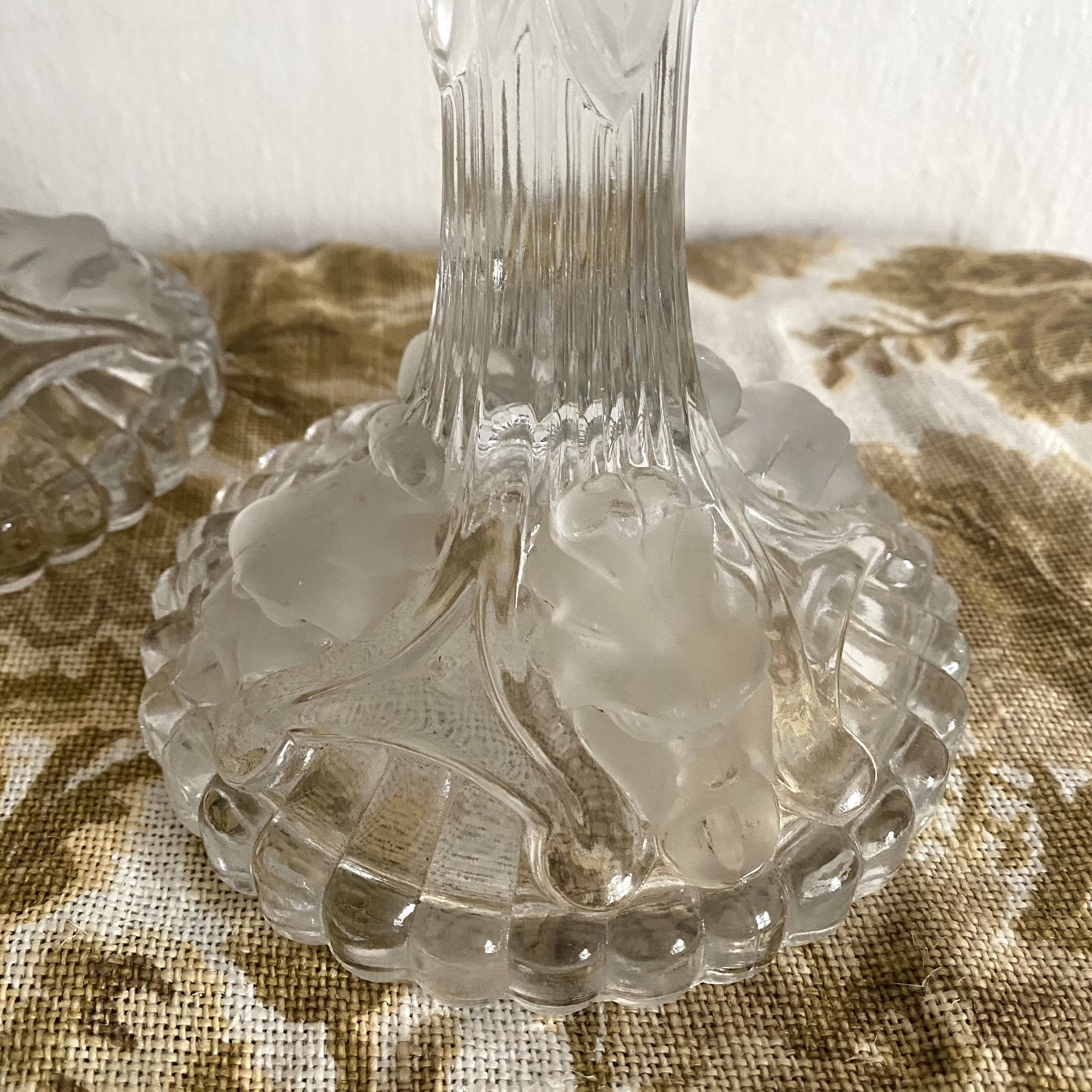 Pair of moulded glass candlesticks, ram heads and masks