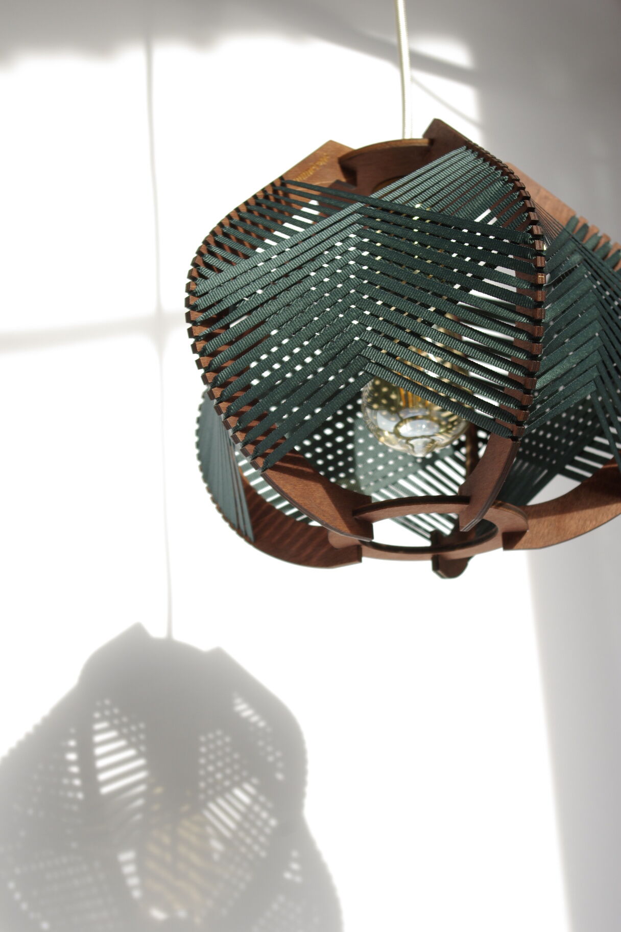 Dark green woven lamp to hang