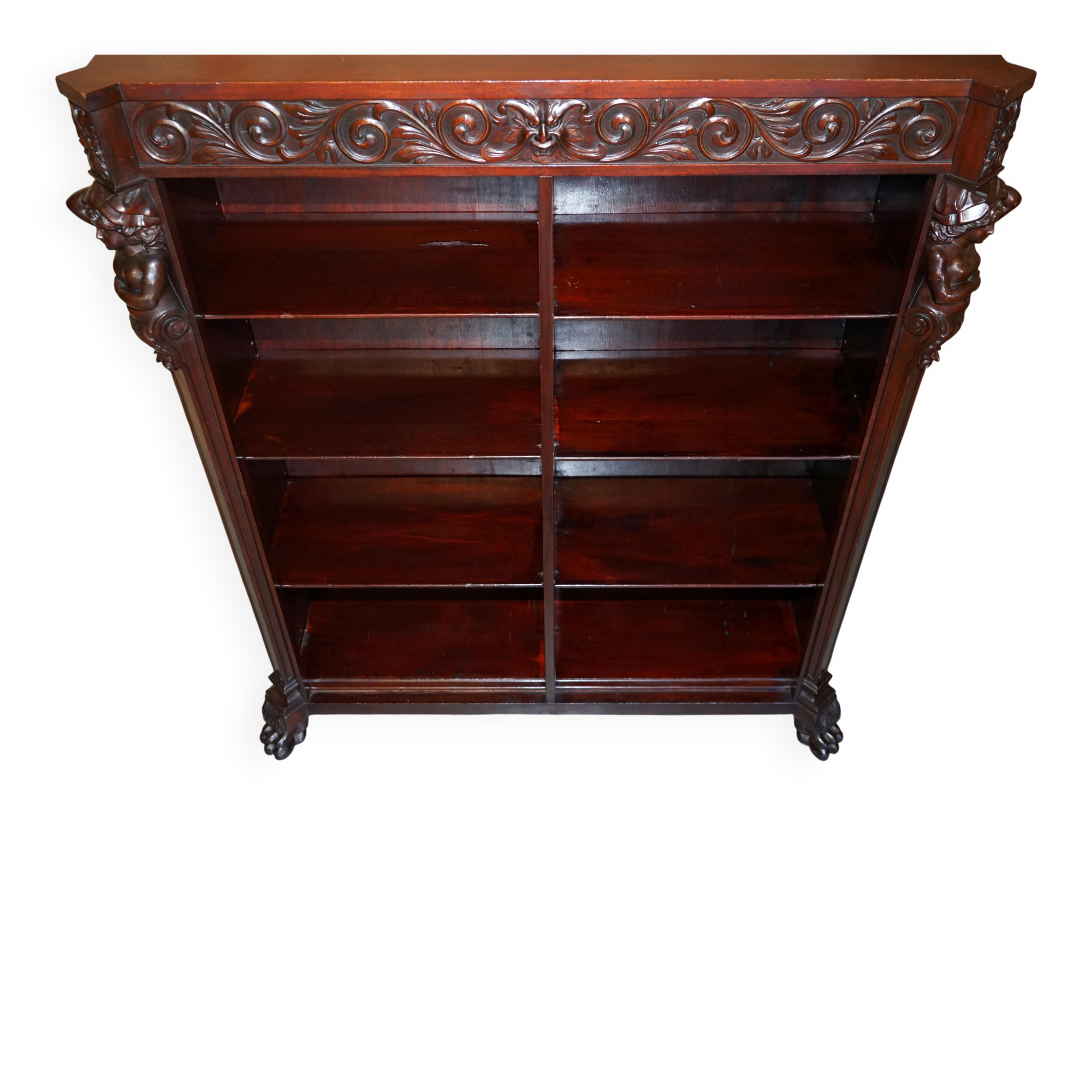 Hand-carved library circa 1900 in hardwood with Hermes statues.