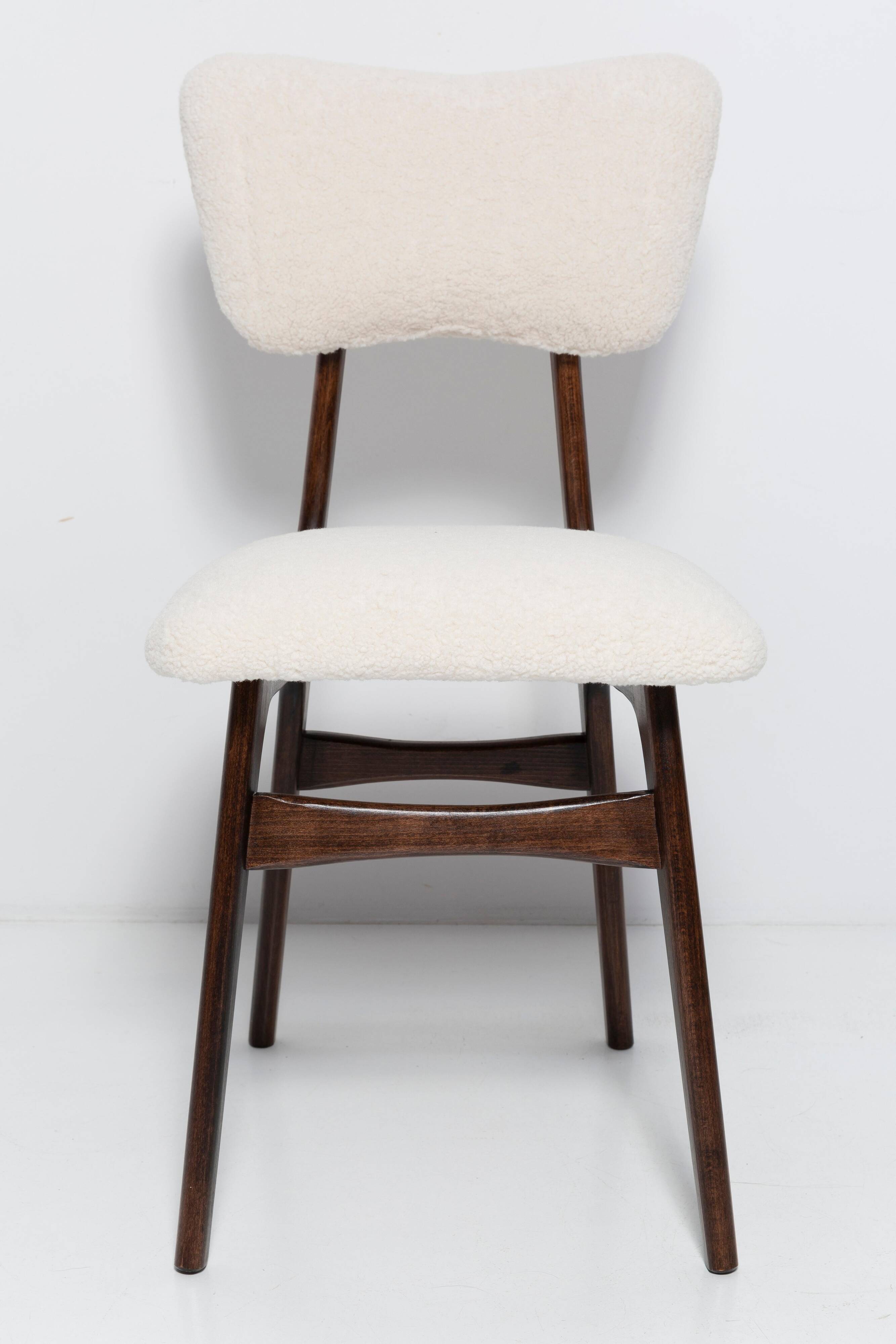 20th-century walnut and light cream boucle butterfly chair, Europe, 1960.