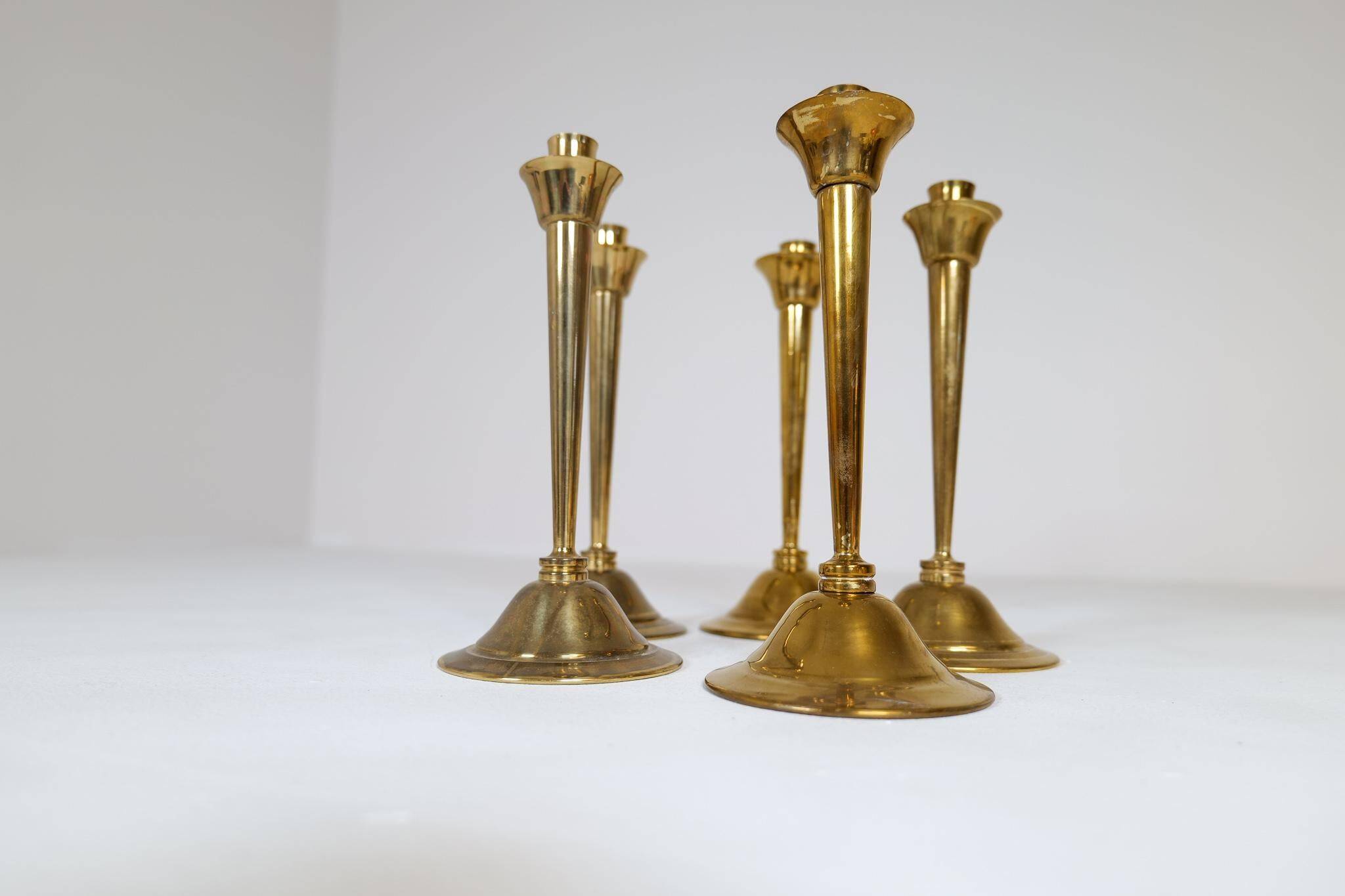 Mid-century set of 5 brass candlesticks by Lars Holmström, Arvika, Sweden.
