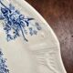 Old Gien plate with carved edges featuring doves and blue flowers, circa 1920-1930.