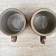 Duo of sandstone pots with handle
