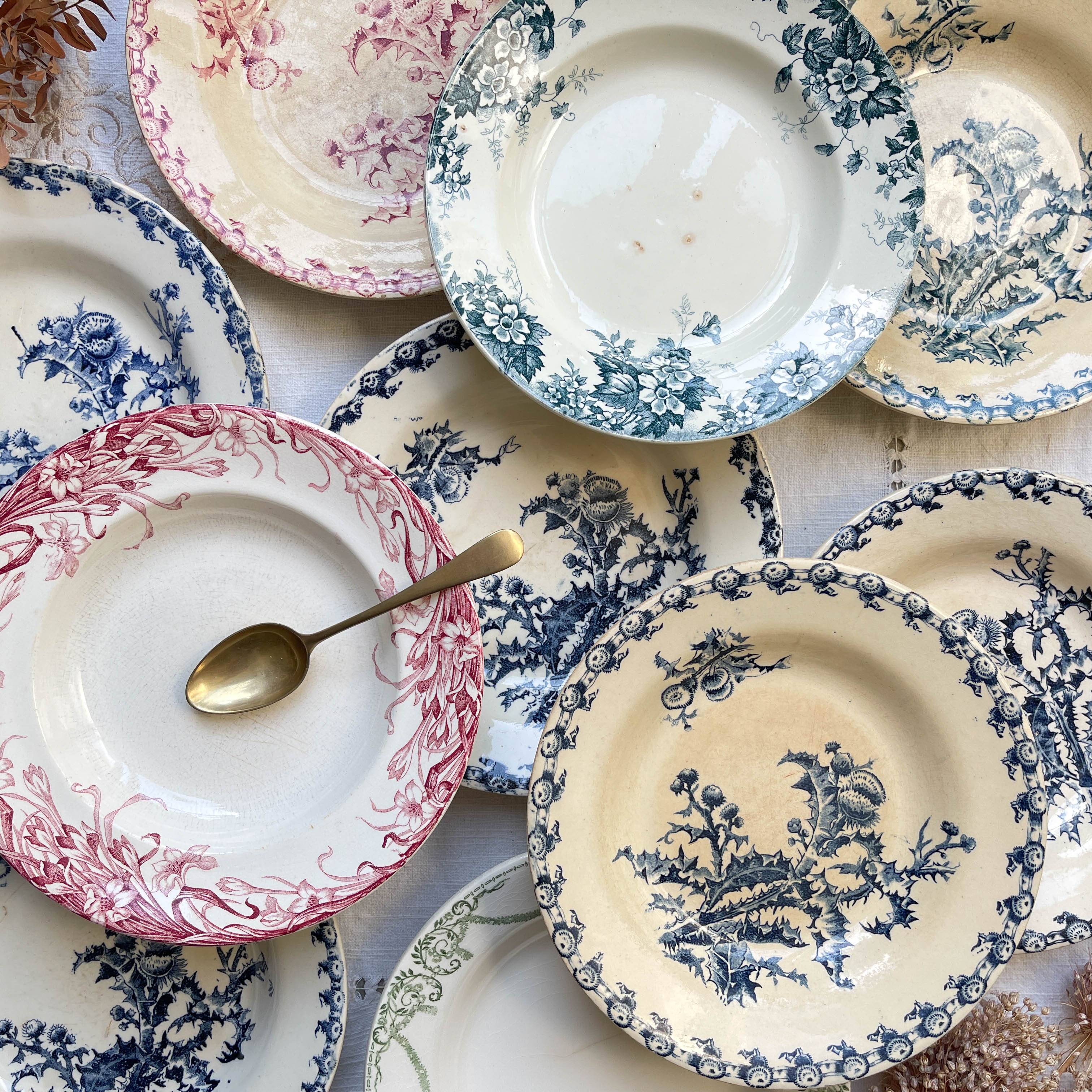 10 mismatched vintage soup plates in blue, green, and red ironstone