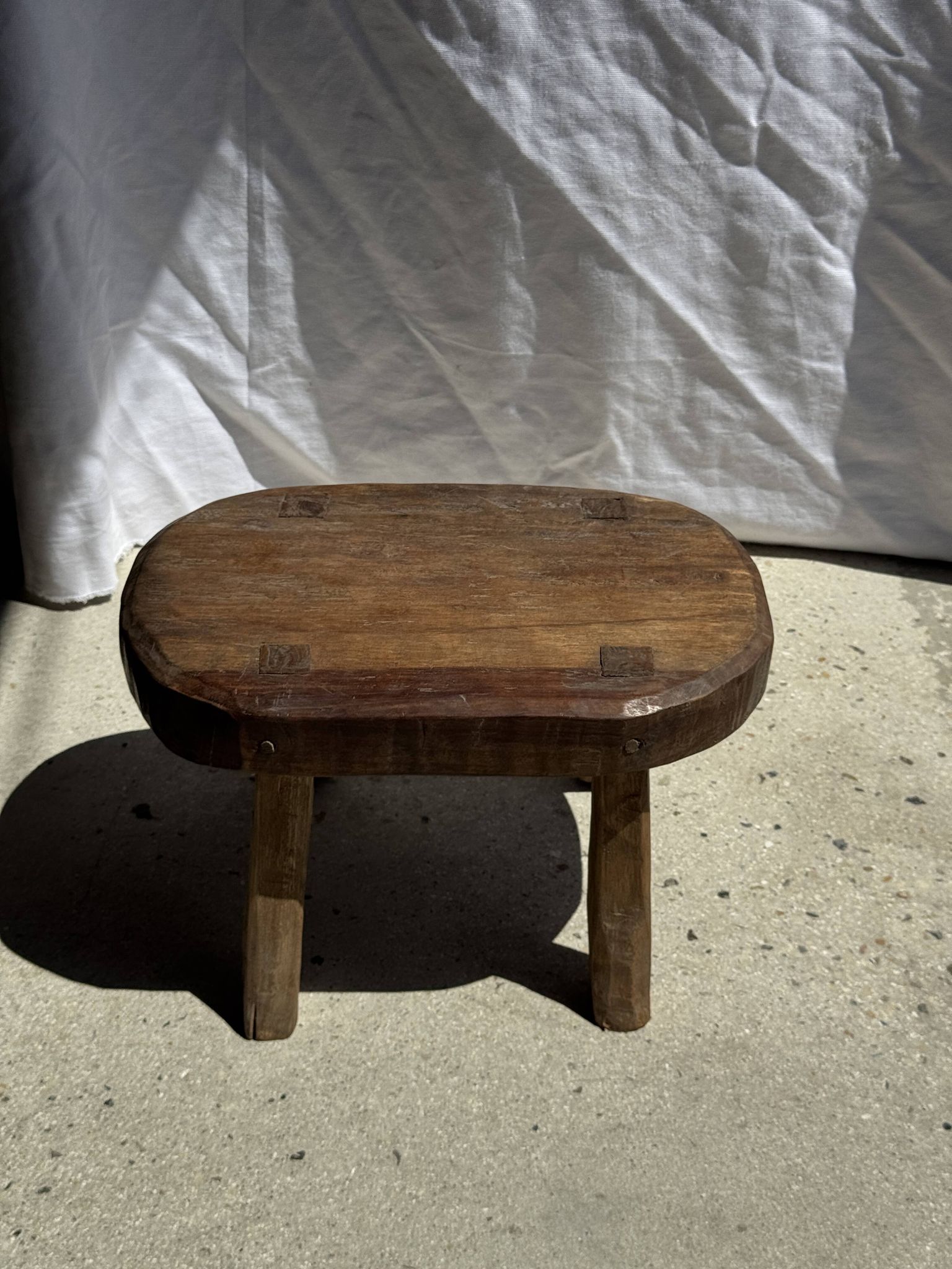 Small stool, oval solid teak accent stool with a two-tone seat.