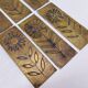 Six cleanliness plaques, flower design, brass.