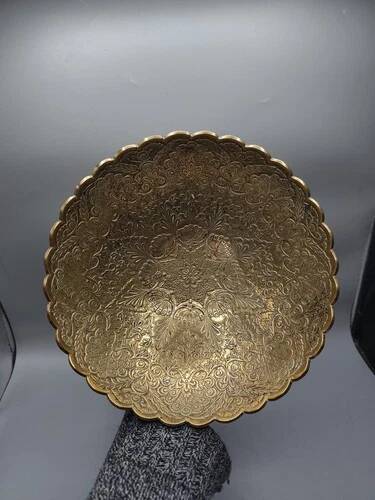 Engraved brass bowl from the mid-20th century with a scalloped edge.