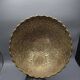 Engraved brass bowl from the mid-20th century with a scalloped edge.