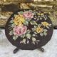 Old adjustable piano stool, blackened wood, metal screws, embroidered seat.