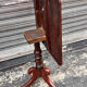 19th-century solid mahogany table with a tilting top and brass mechanism.