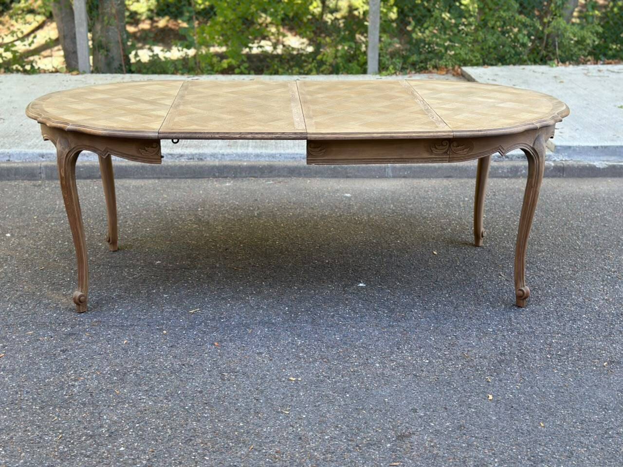 Round extendable dining table Louis XV stripped in solid oak 1950