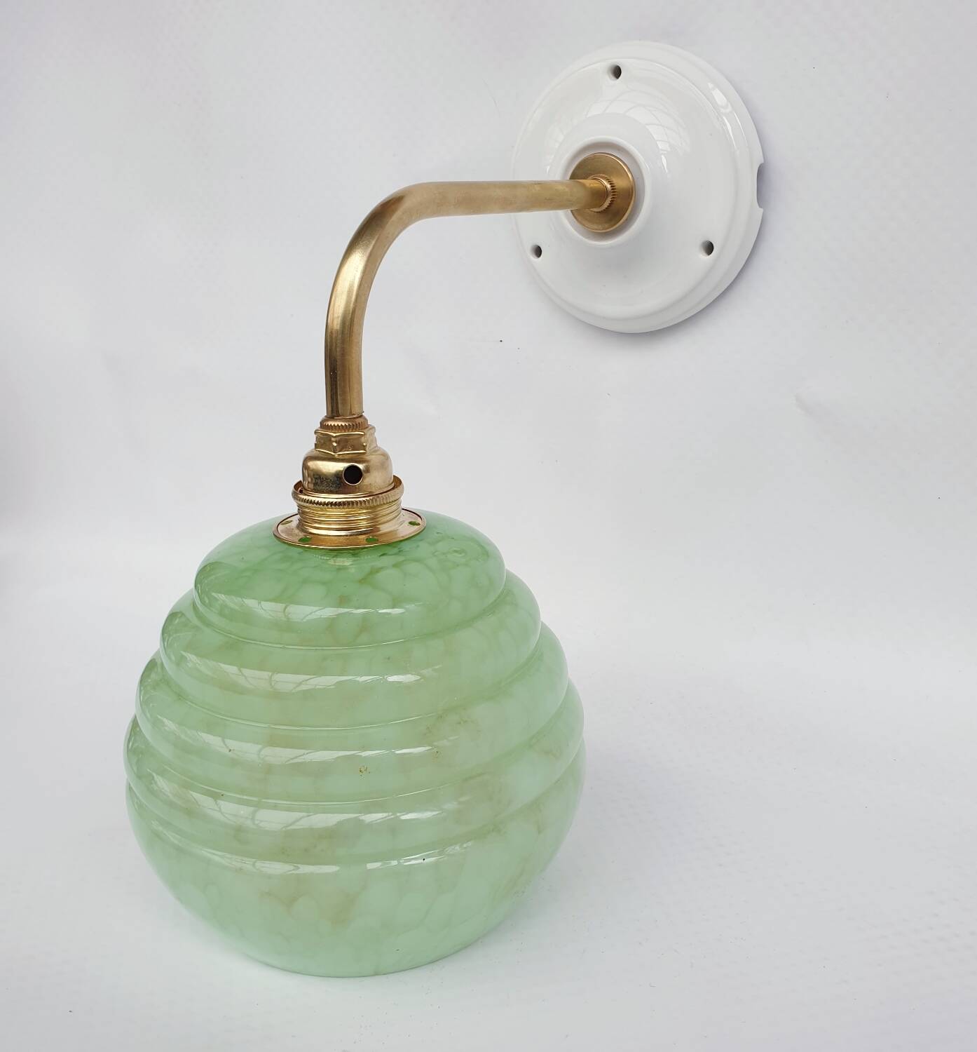 Brass collar and speckled glass wall lamp