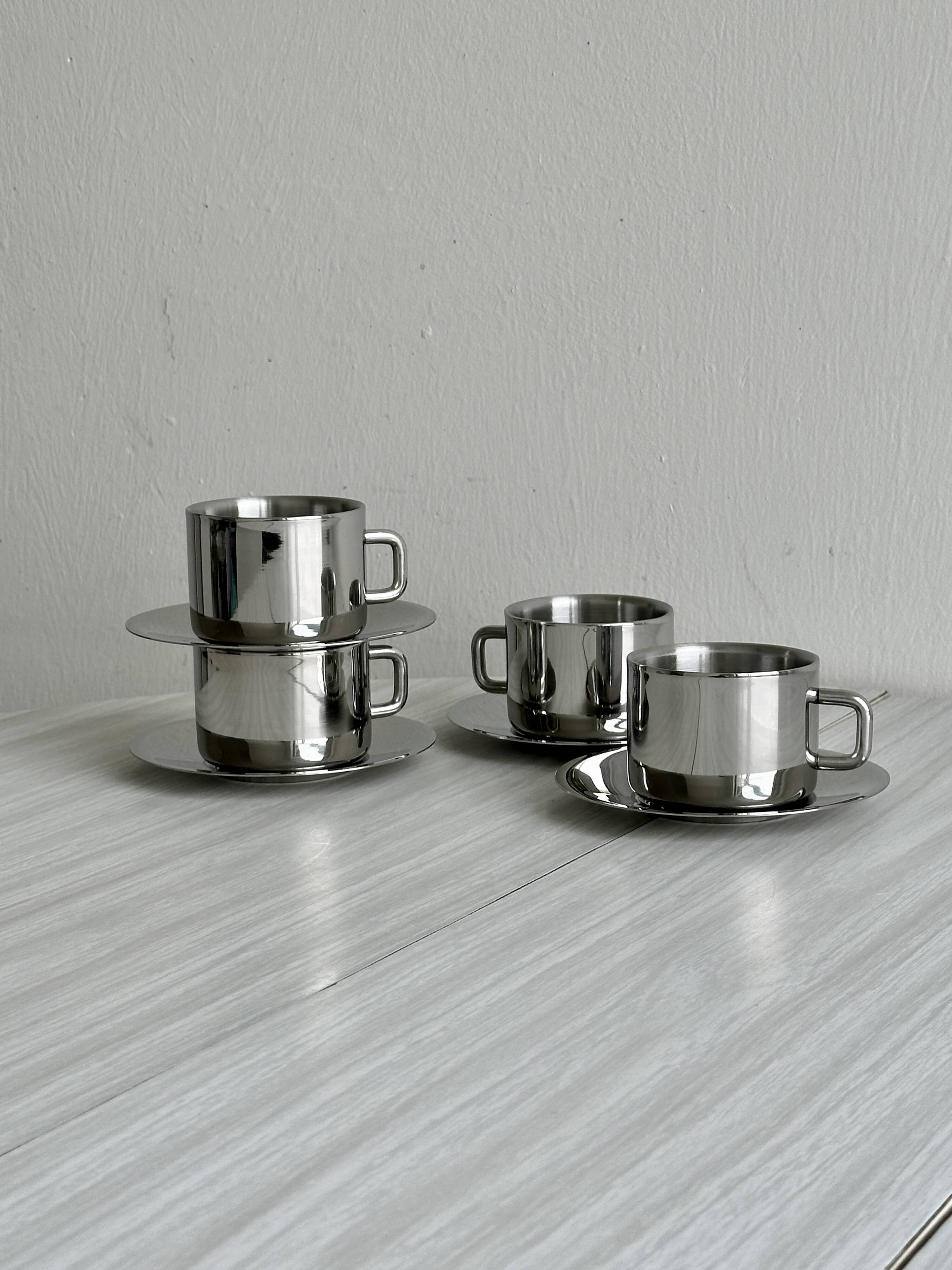 Set of 4 stainless steel coffee cups with saucers