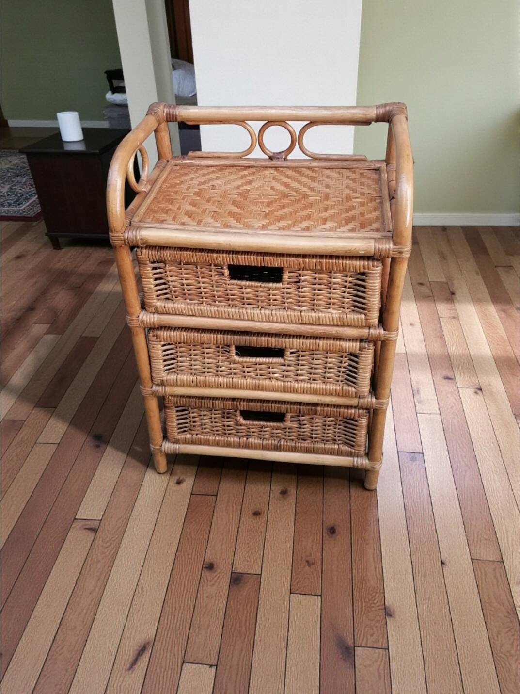 Small storage unit / freestanding shelf in light rattan.