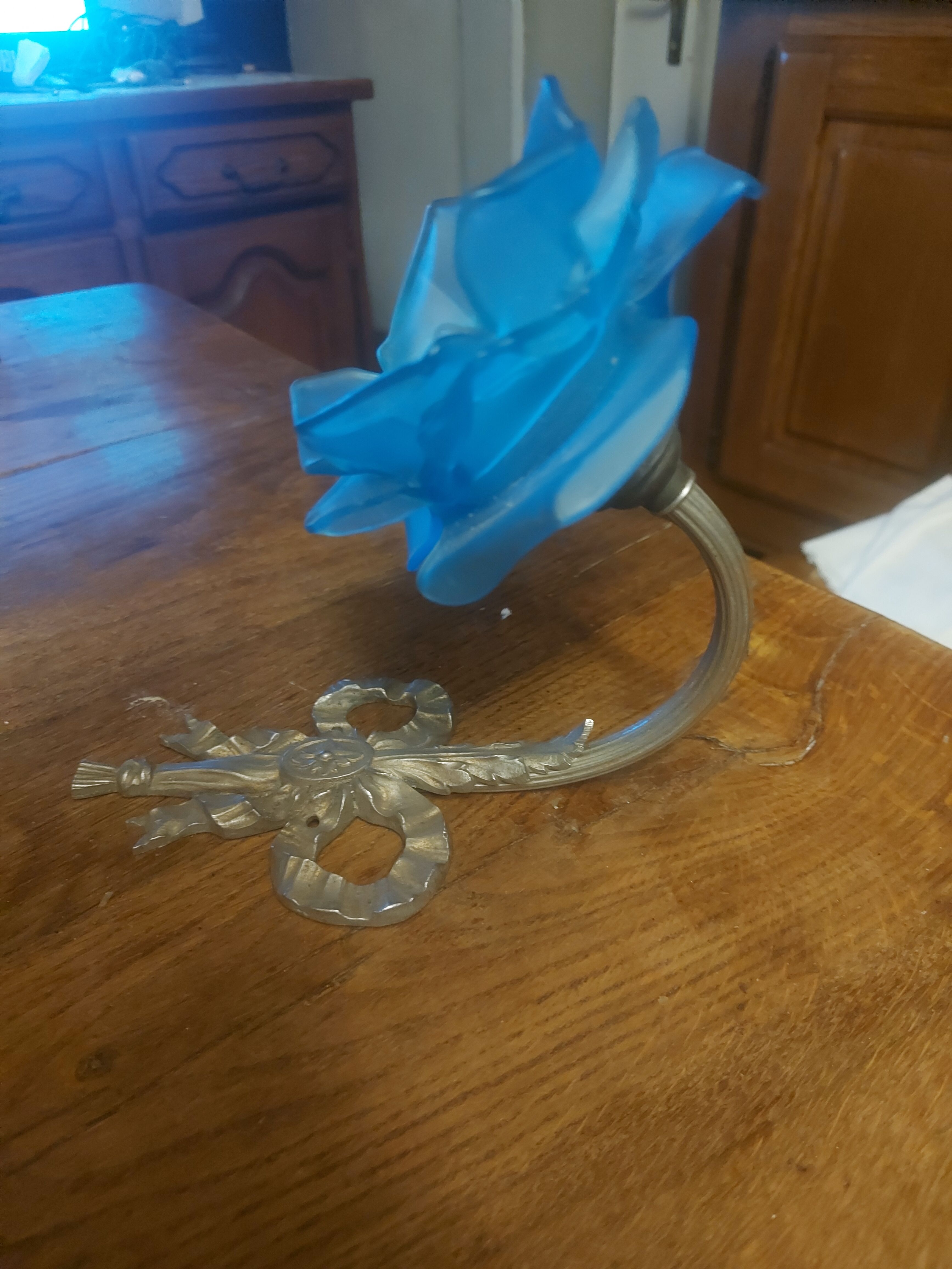 Art Deco style wall light in frosted blue glass with silver metal support.