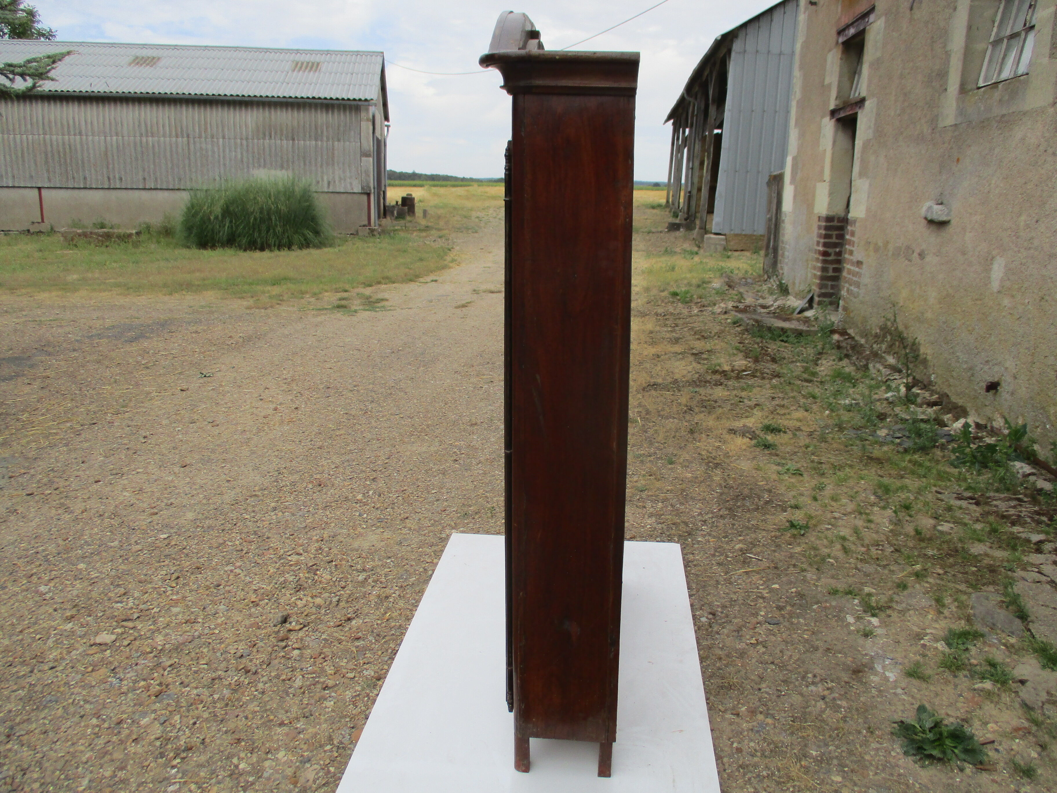 Small solid wooden cabinet with a gendarme hat