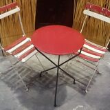 Old tripod table with folding chairs