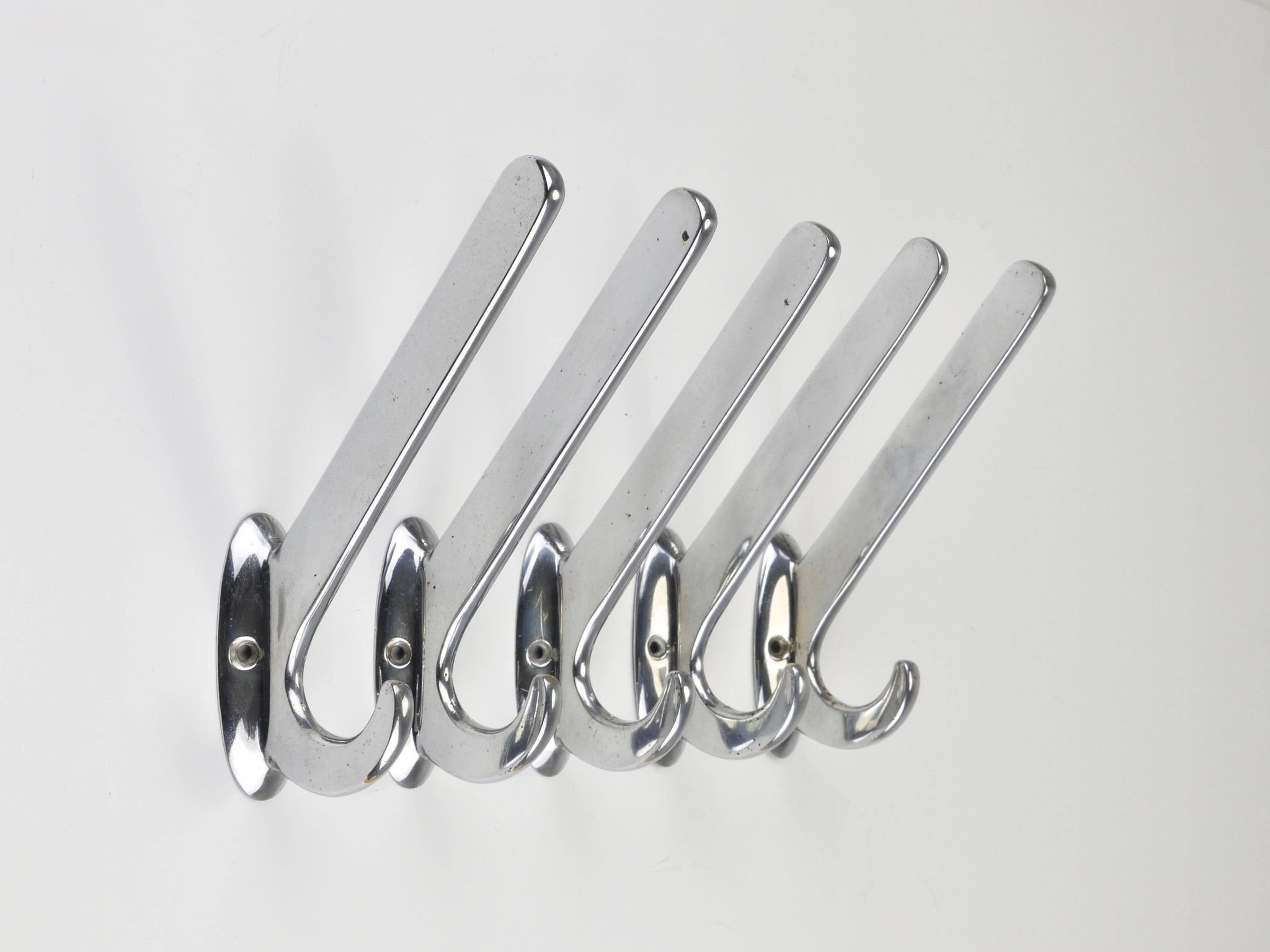 Up to 5 large Art Deco Bauhaus wall hooks in nickel and brass, Vienna, 1930s.