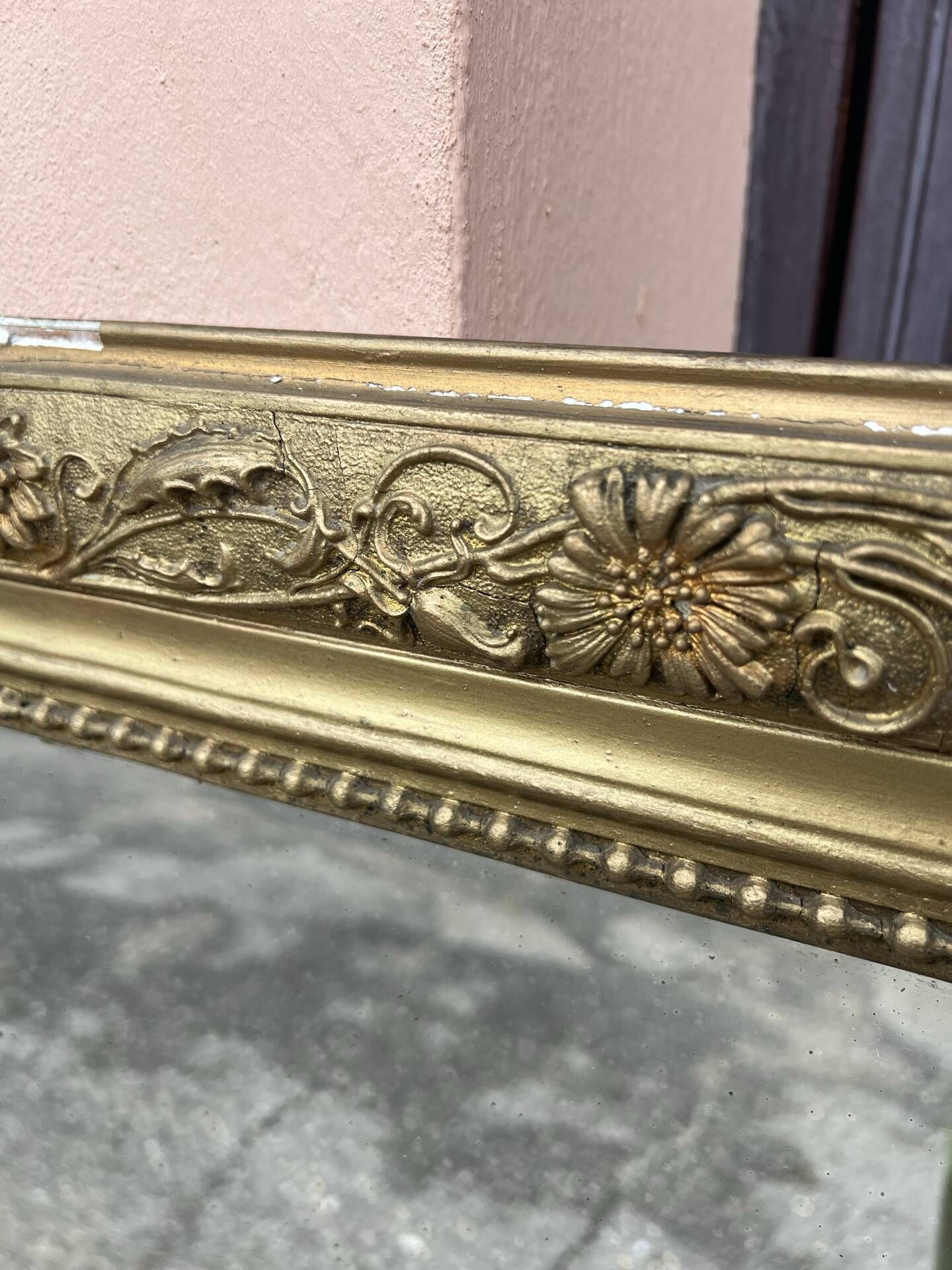 Large Louis Philippe mirror in carved gilded wood with mercury glass.