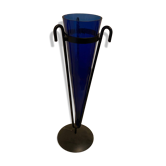 Cobalt blue vase on a metal structure.