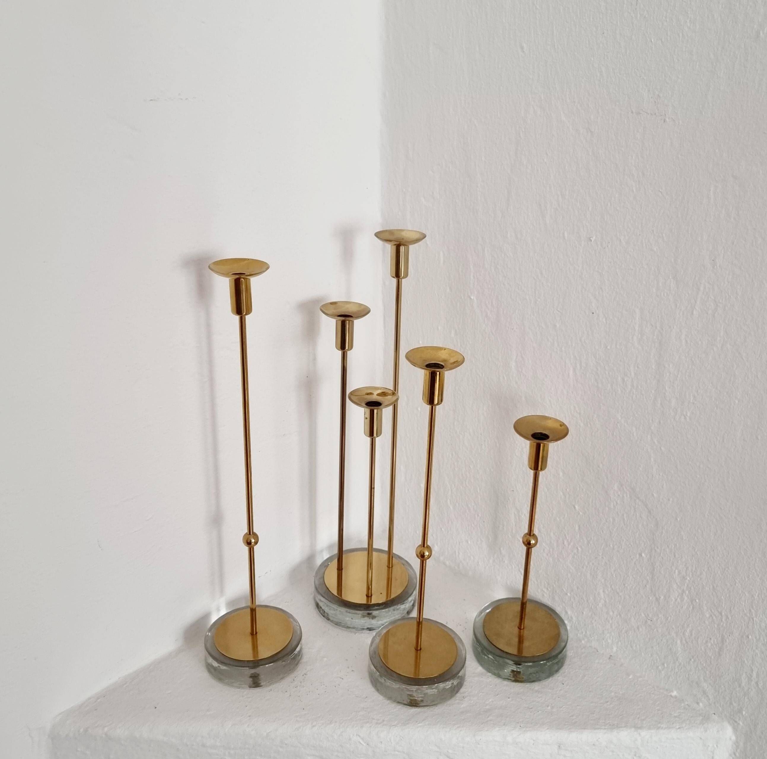 Gunnar Ander, four candlesticks, brass and glass, Ystad Metall, Swedish modern.