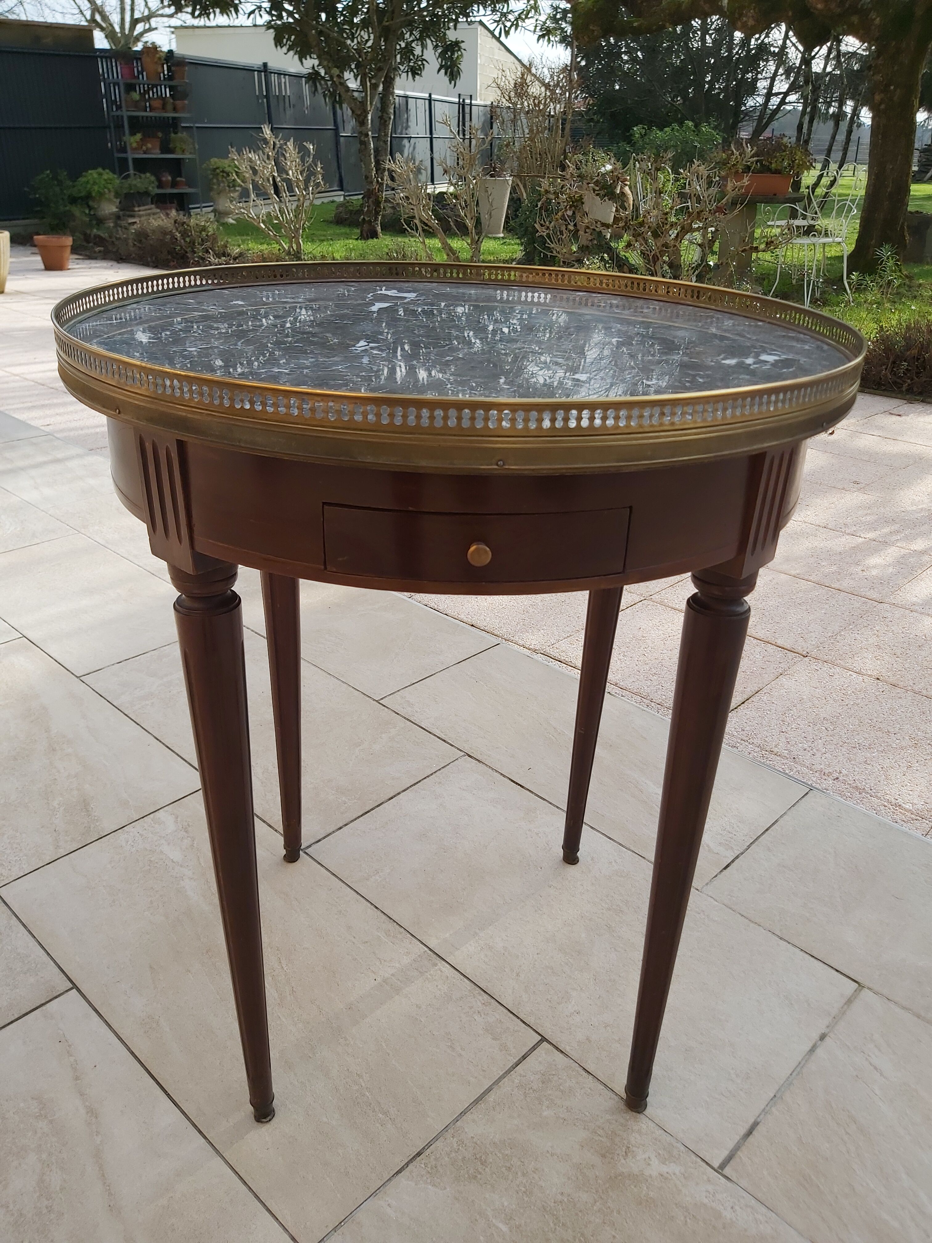 Gray marble mahogany pedestal table and brass gallery
