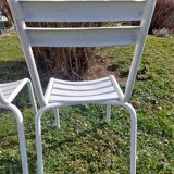 pair of white metal chairs, Tolix style