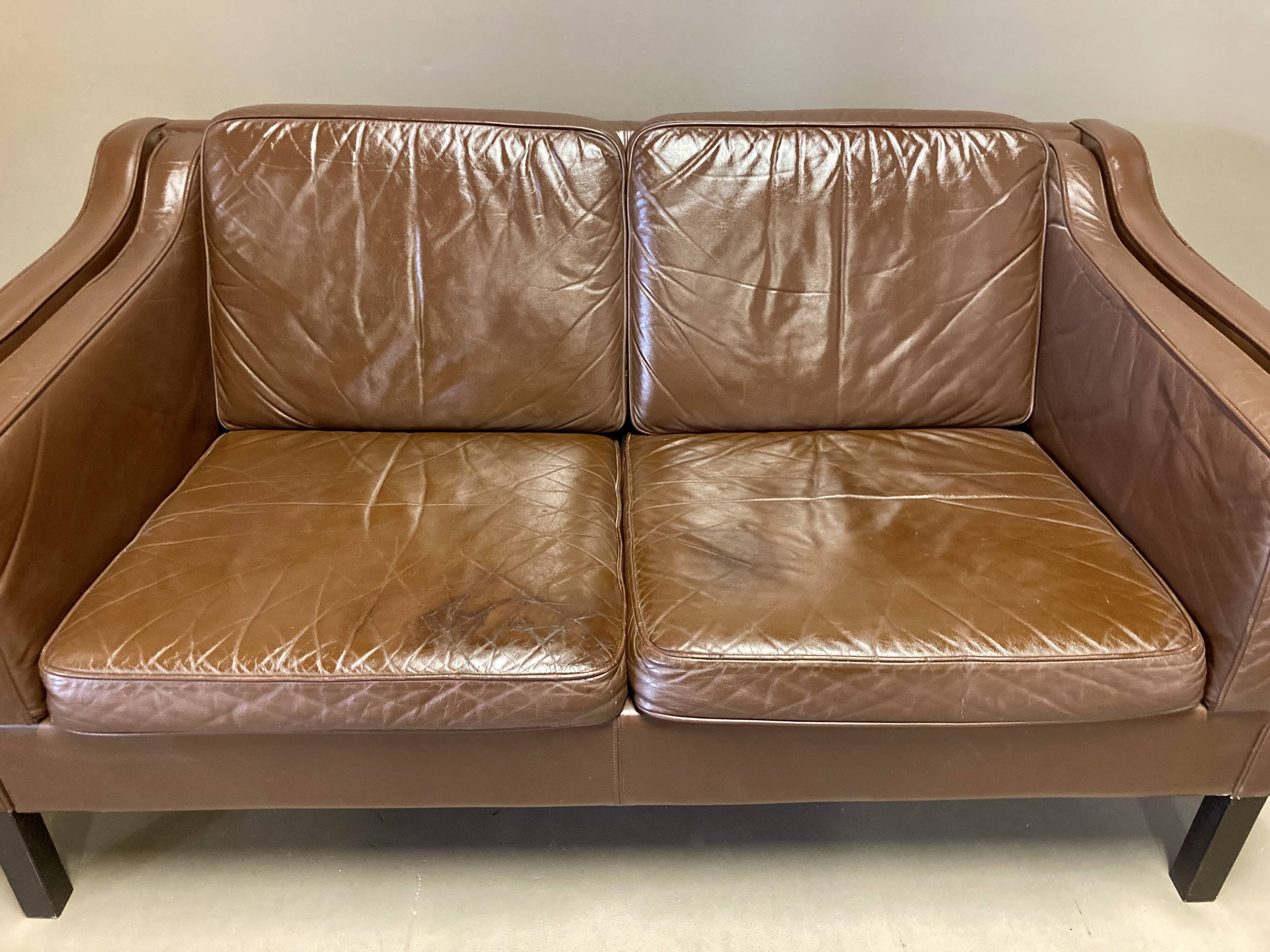 Scandinavian design 2-seater leather sofa.