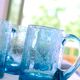 Four Biot glass mugs blue bubbled glass