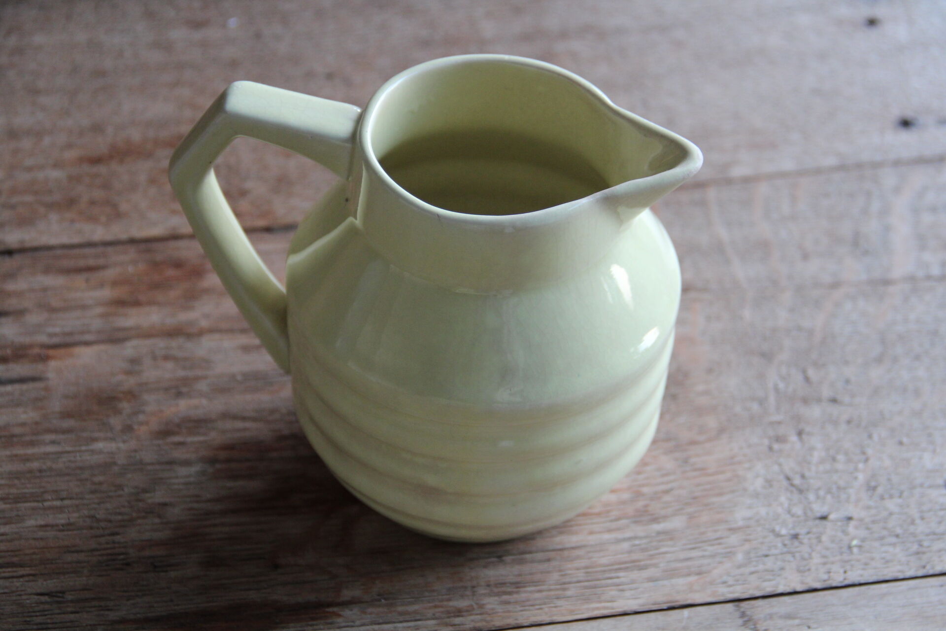 Art-deco pitcher in pale yellow earthenware