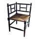 Corner chair made of turned wood with a straw seat.